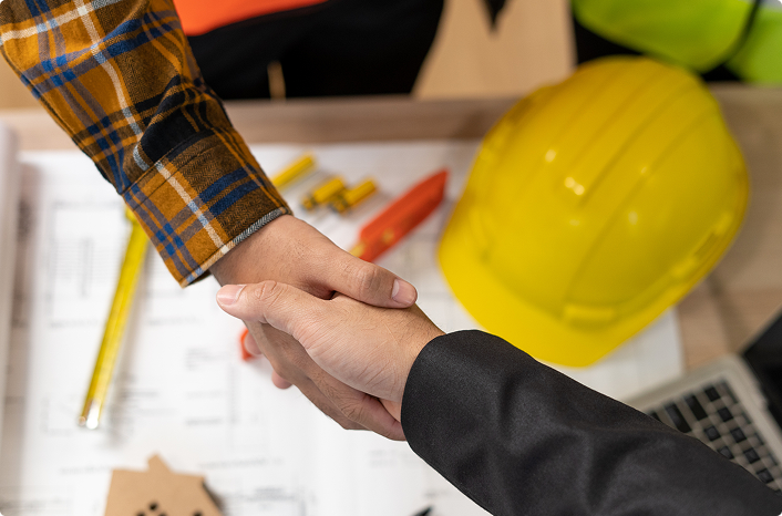 Engineer with hard hat reviewing plans